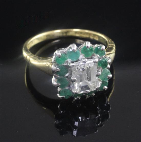A 1980s 18ct gold, diamond and emerald cluster ring, size L.